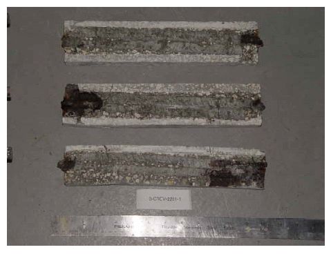 Extensive corrosion products are apparent at two of the trace ends with lesser amounts at the others.