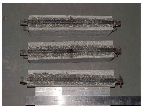 Modest corrosion products are apparent where the simulated crack intersected one of the bars, but these are minor for the other two.