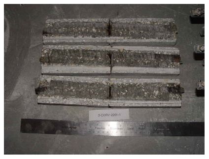 Corrosion products are apparent where the simulated crack intersected each of the three bars and at the ends of the traces.