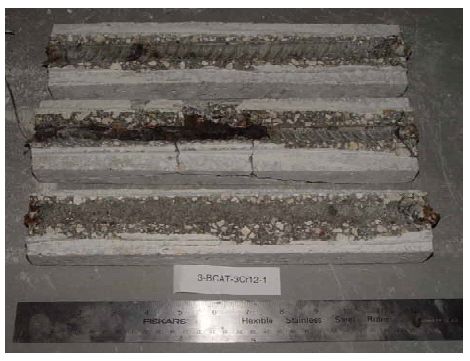 The photo shows heavy corrosion products along one bar trace, modest corrosion products along a second, and minimal products on the third.