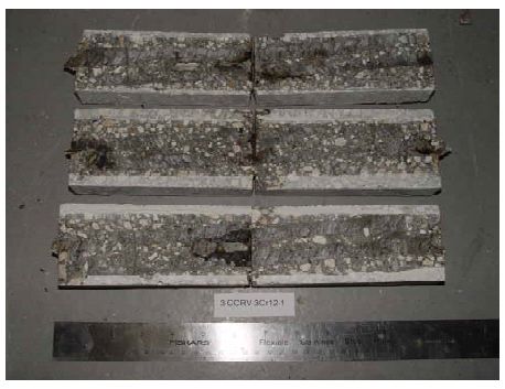 The photo shows corrosion products at four of the six bar ends and at the three locations where the simulated crack intersects each of the three bar traces.