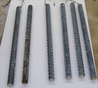 Two top bars show corrosion products. Four bottom bars exhibit little corrosion damage. In uncracked concrete, moderate amounts of corrosion products are observed on the top mat of conventional reinforcement. Approximately 40 percent of the surface area of the top mat of the steel shows some degree of corrosion. Corrosion on the bottom mat is limited to small isolated regions.