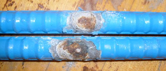 The multiple-coated (MC) bars were subjected to disbondment testing at locations that were intentionally damaged prior to the initiation of the corrosion test. The loss of zinc below the epoxy is apparent.
