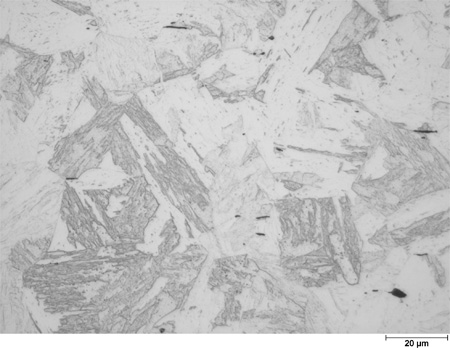 This photomicrograph shows an etched microstructure of a 9Cr plate from heat 67-V1-68 in the as-normalized condition zoomed to 500X. It shows randomly scattered grains of different shades of gray all showing interior lath-like structure. Grain boundaries are generally straight. The grains are about twice the size of the scale mark. A scale mark about 15 percent of the length of the photo is marked 0.78 mil (20 microns).