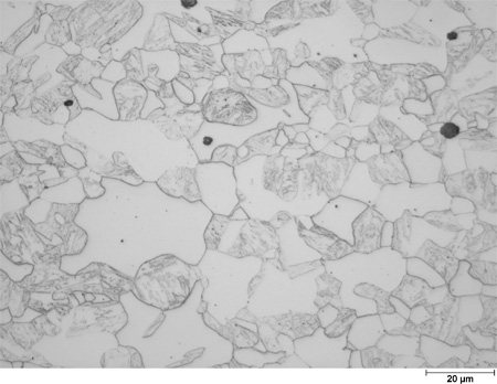 This photomicrograph shows an etched microstructure of a 9Cr2Si plate from heat 67-V1-71 in the as-normalized condition zoomed to 500X. It shows randomly scattered grains of different shades of gray ranging from white to dark gray. Some of the gray grains have interior structure. The white grains have clear rounded boundaries, and the grain diameters are about the size of the scale mark. A scale mark about 15 percent of the length of the photo is marked 0.78 mil (20 microns).