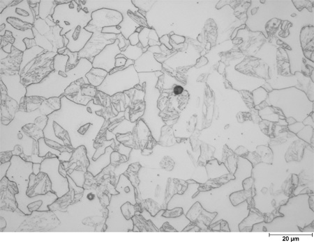This photomicrograph shows an etched microstructure of a 7Cr2Si plate from heat 67-V1-73 in the as-normalized condition zoomed to 500X. It shows randomly scattered grains of different shades of gray ranging from white to dark gray. Some of the gray grains have interior structure. The white grains have clear rounded boundaries, and the grain diameters are about the size of the scale mark. The scale mark about 15 percent of the length of the photo is marked 0.78 mil (20 microns).