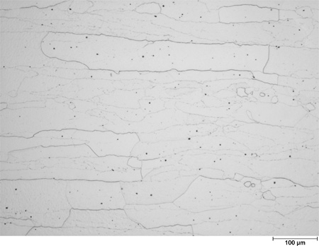 This photomicrograph shows an etched microstructure of a 7Cr2Al plate from heat 67-V1-75 in the as-normalized condition zoomed to 50X. It shows elongated white grains with an aspect ratio of about 10 to 1. A scale mark about 15 percent of the length of the photo is marked 7.8 mil (200 microns).