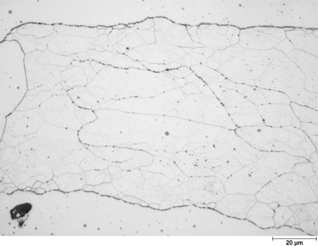 This photomicrograph shows an etched microstructure of a 7Cr2Al plate from heat 67-V1-75 in the as-normalized condition zoomed to 500X. It shows large grains that are filled with randomly scattered subgrains of different shades of white to light gray. The grain boundaries are decorated with black precipitates. A scale mark about 15 percent of the length of the photo is marked 0.78 mil (20 microns).