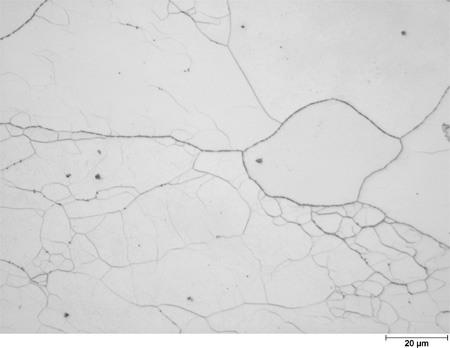 This photomicrograph shows an etched microstructure of a 5Cr2Si2Al steel plate from heat 67-V1-80 in the as-normalized condition zoomed to 500X. It shows large grains that are filled with randomly scattered subgrains of different shades of white to light gray. The grain boundaries are decorated with black precipitates. A scale mark about 15 percent of the length of the photo is marked 0.78 mil (20 microns).