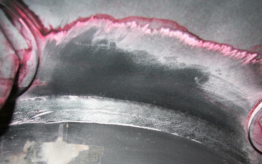 This photo is a close-up of a the fillet weld of specimen 1U3. Generally, the surface of the weld is dimpled, indicating it was needle peened.