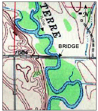 Figure 37. Map. Plan view of Swift County Route 22 over the Pomme de Terre River, Minnesota (no scale). This map shows the bridge crossing immediately downstream from a bend in the river. The river is generally flowing south in a circuitous path. Immediately upstream from the bridge, the river is flowing west right against the roadway embankment, and at the point of the bridge crossing, the river is flowing south. At a point several bends upstream from the bridge, a tributary joins the river from the west. The topography is steep to the west, and relatively flat to the east.