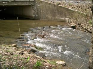 Figure 17. Cross vane downstream of bridge over Potter Run, Pennsylvania. Photo. The cross vane shown in the figure causes the flow to pool just upstream and under the bridge, slowing the high velocity and minimizing scour under the bridge and along the banks.