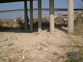 Figure 31. Buena Vista Creek, Pacific Coastal-downstream under bridge. Photo. This is looking downstream under the bridge. The photo shows a sandy bed and sandy bank materials.