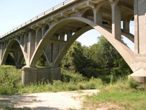 Figure 73. Saline River, Great Plains-looking downstream at bridge. Photo. This is looking downstream at the bridge. The arched bridge spans a large part of the flood plain.