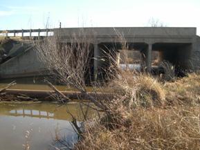 Figure 78. West Elk Creek, Central Plains-looking downstream at bridge, photo 1. Photo. This is the West Elk Creek in the Central Plains region looking downstream at the bridge. The bank vegetation is grasses and annuals. 