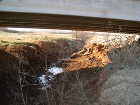 Figure 84. Beaver Creek, Central Plains-facing upstream under bridge. Photo. This is looking upstream under the bridge. As shown in the photo, widening and bed degradation threaten the bridge. 
