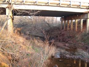 Figure 88. Brush Creek, Central Plains-downstream under bridge. Photo. This is looking downstream under the bridge. The bank material is beginning to slough.