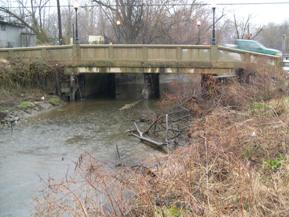 Figure 143. Mill Stream Branch, Atlantic Coastal Plain-looking downstream at bridge. Photo. This is looking downstream at the bridge. The channel is well-aligned with the bridge. 