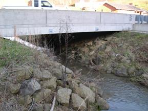 Figure 180. McKnown Creek, Appalachian Plateau-looking upstream at bridge. Photo. This is looking upstream at the bridge and riprap stabilization.
