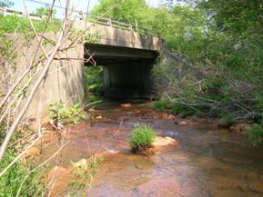 Figure 191. Reids Run, Appalachian Plateau-looking downstream at bridge. Photo. This is looking downstream at the bridge. The channel thalweg is hugging the left abutment. 