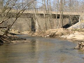 Figure 216. Middle Patuxent River, Piedmont-looking upstream at bridge. Photo. This is looking upstream at the bridge. The flow divides around the island.