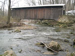 Figure 224. Little Elk Creek, Piedmont-looking downstream at bridge. Photo. This is looking downstream at the bridge. The bed material contains large rocks. The right bank is slightly eroded due to slow lateral shifting of the channel.