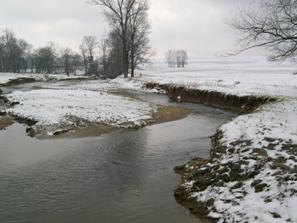 Figure 225. Big Beaver Creek, Piedmont-upstream from bridge. Photo. This is the Big Beaver Creek in the Piedmont region looking upstream from the bridge. All vegetation has been removed for farming and cattle within 152.5 meters upstream of the bridge. The flow divides around a very large midchannel bar. The obstruction causes the flow to impinge on the right bank causing considerable erosion and a highly irregular bank width. 