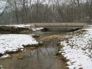 Figure 227. Big Beaver Creek, Piedmont-looking downstream at bridge. Photo. This is looking downstream at the bridge. The channel is poorly aligned with the channel due to the midchannel bar and bank erosion. 