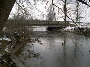 Figure 228. Big Beaver Creek, Piedmont-looking upstream at bridge. Photo. This is looking upstream at the bridge. The channel exits the bridge opening at the center of the span.