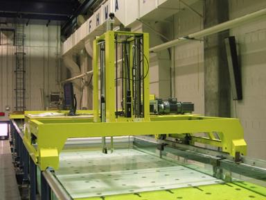 Figure 53. Photo. Automated flume carriage in the J. Sterling Jones Hydraulics Laboratory. This figure shows a view of the flume highlighting an instrument carriage that spans the width of the flume and is capable of moving along the length of the flume on a rail system. The instrument carriage serves as the platform for mounting various types of measurement devices.