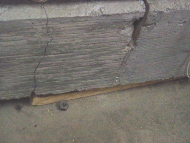This photo shows a crack pattern away from the joint location of two slabs where a single crack is formed on left side of the concrete pavement slab joint at the dowel edge location. The crack extends through from top to bottom depth of the concrete slab designated as slab number 3 in table 3.