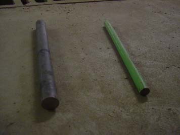 Figure 4. Photo. Steel dowels 3.81 and 2.54 cm (1.5 and 1.0 inches) in diameter. The photo shows two circular steel dowel bars of 3.81 and 2.54 cm (1.5 and 1.0 inches) diameter with a length of 45.72 cm (18 inches). These bars are grade 40 plain uncoated steel or epoxy coated steel and have been used for laboratory experiments and field installations.
