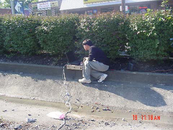 This photo shows monitoring of strain gauge readings due to traffic load on fiber reinforced polymer and steel dowel bars embedded in the rehabilitated pavement. The data are being recorded through a data acquisition system by a Constructed Facilities Center, West Virginia University member. 