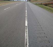 This photo shows a two-lane test deck in Tusculum, TN, with a test marking partially eradicated by wear. 