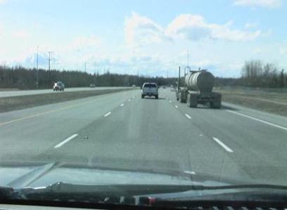 This photo shows Glenn Highway in Anchorage, AK, which has three lanes in each direction of the divided highway.