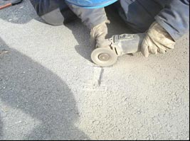 This photo shows the shape of the sensor being carved out in the cement by a worker.
