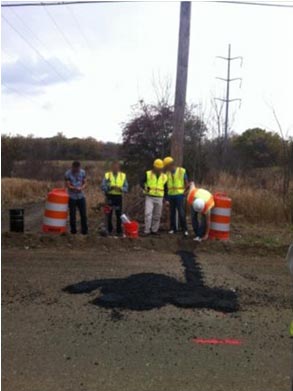 This photo shows the sensors completely covered with asphalt in the middle of the roadway.