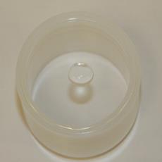 This photo shows an inverted plastic x-ray fluorescence spectroscopy  sample cup with a plastic film stretched across the bottom.