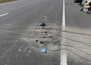 Figure 27. Photo. Grooving of pavement for sensor installation. This photo shows the grooved pavement to accommodate the sensor wires.