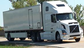 Figure 2. Photo. Greenwood TSD. This photo shows the Greenwood Engineering Traffic Speed Deflectometer (TSD), which is a semi-trailer with four axles. Underneath the semi-trailer toward the rear end is an apparatus containing the laser used to measure deflection velocities.