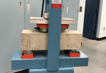 Figure 7a. Testing machine set up for standard beam. This image shows the testing apparatus set up to test a standard size beam. The beam its perfectly into the apparatus.