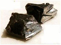 Figure 2. Photo. Photograph of lithium metal. This image shows two grey-colored lustrous rocks.
