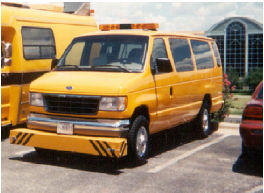 This figure shows a photograph of a van with the K.J. Law Engineers T-6600 profiler. The sensor bar that houses the height sensors is located on the front of the vehicle down low where the bumper would be. It is a long rectangular-shaped piece that is the full width of the vehicle