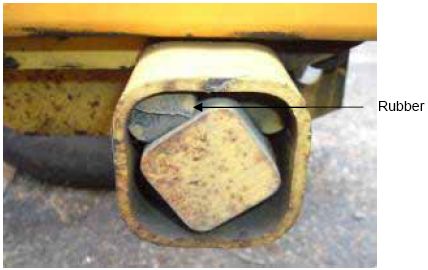 Photograph shows torsion tube housing. An arrow indicates the location of the rubber that has separated from the housing and is no longer intact.