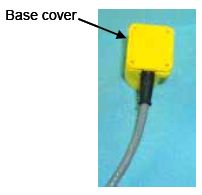 Photograph shows a plastic base cover positioned on the silicone filled housing. An arrow indicates the location of the base cover.