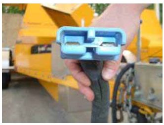Close-up photograph shows a trailer-to-vehicle charge plug that connects the power supply between the vehicle and the trailer.