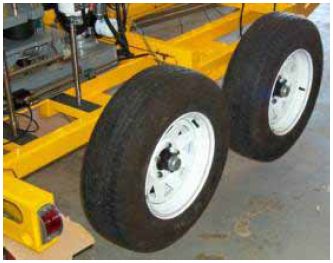 Photograph shows two trailer tires on the same side of the trailer.