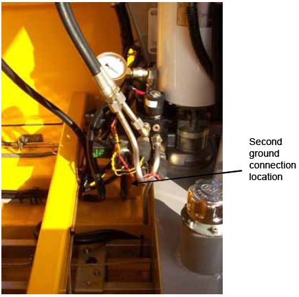 Photograph shows second ground pole on the F W D trailer frame. An arrow indicates the location of the second ground connection