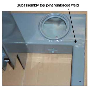 Photograph shows reinforced welds on the top the subassembly. Arrow indicates the location of the reinforced top joint and the reinforced bottom joint.