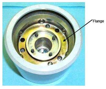 Photograph shows an outer flange inserted into the outer shell above the inner ring. An arrow indicates the location of the flange